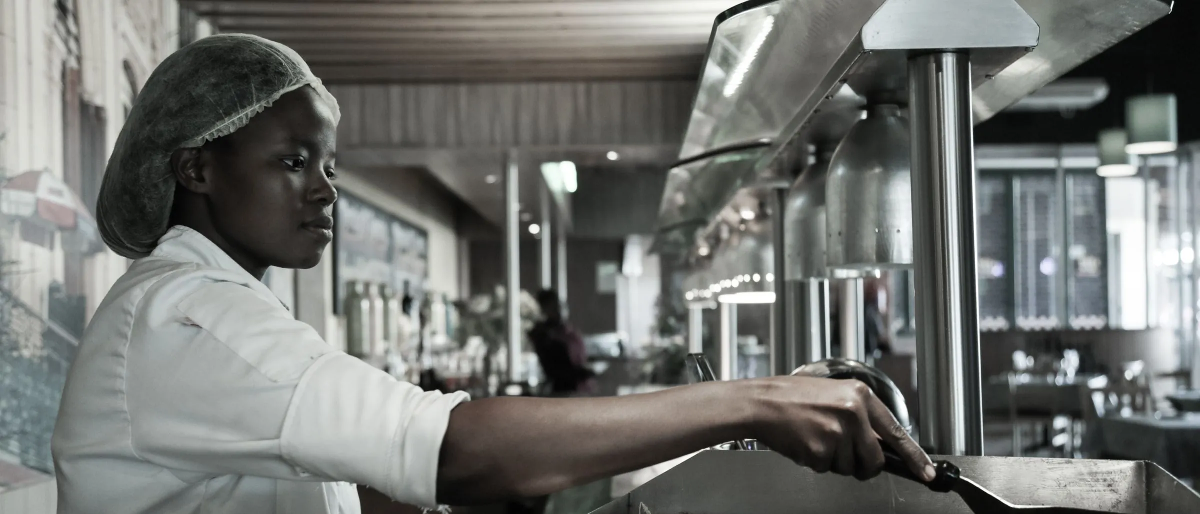 A chef cooking in a commercial restaurant kitchen in Kempton Park.