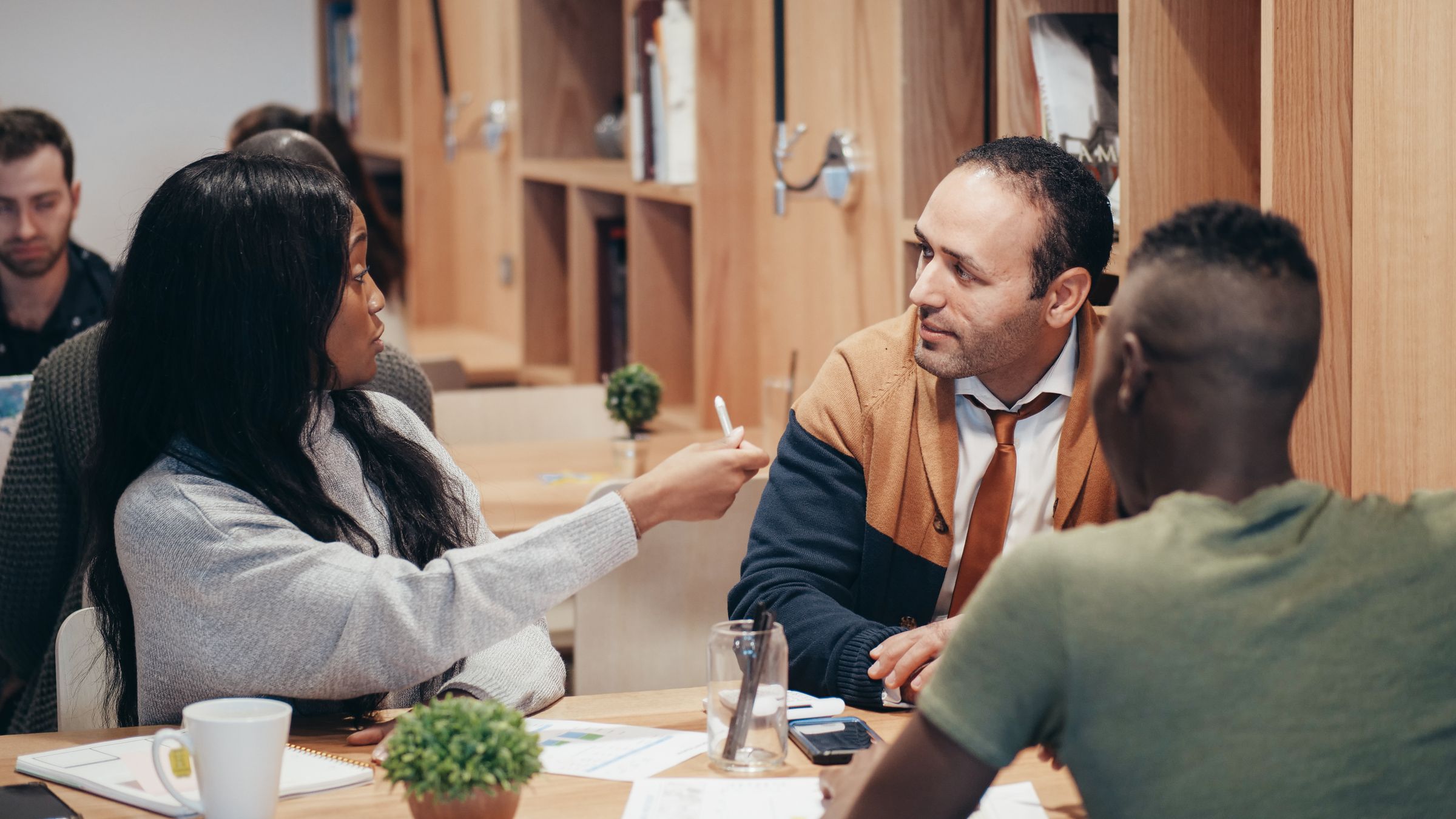 Creative team discussing work around a table