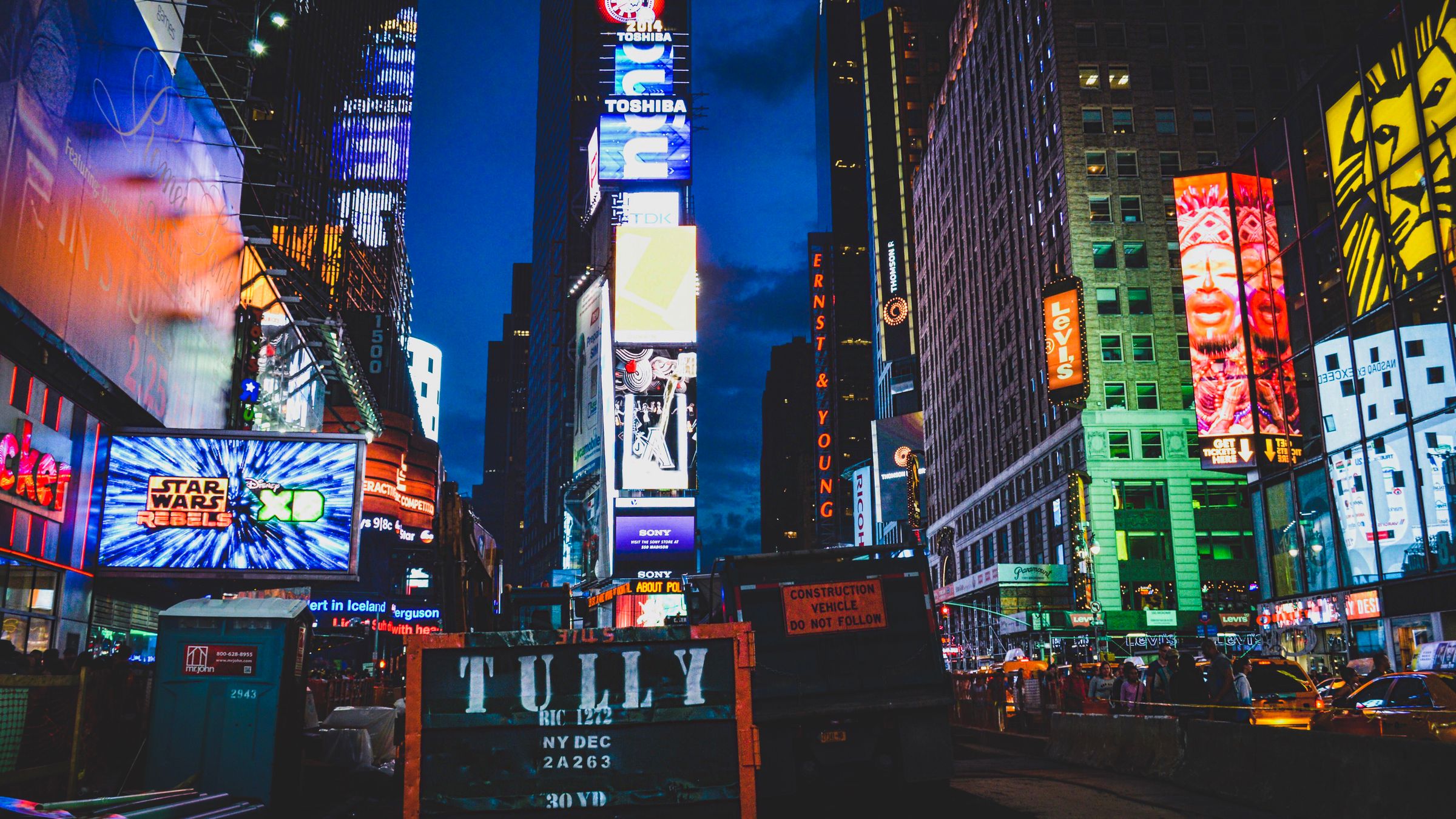 Lit billboards in a city at night